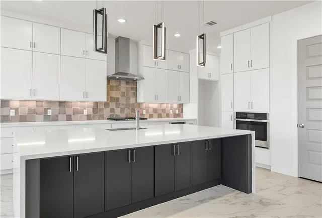 a kitchen with kitchen island granite countertop a sink stainless steel appliances and cabinets
