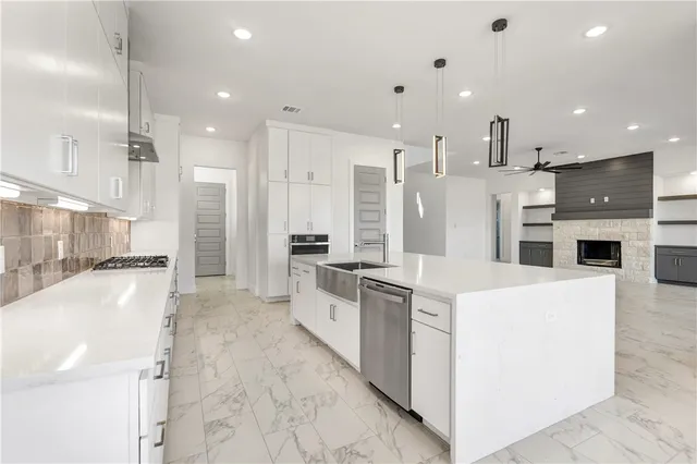 a bathroom with a toilet a sink a mirror and bathtub