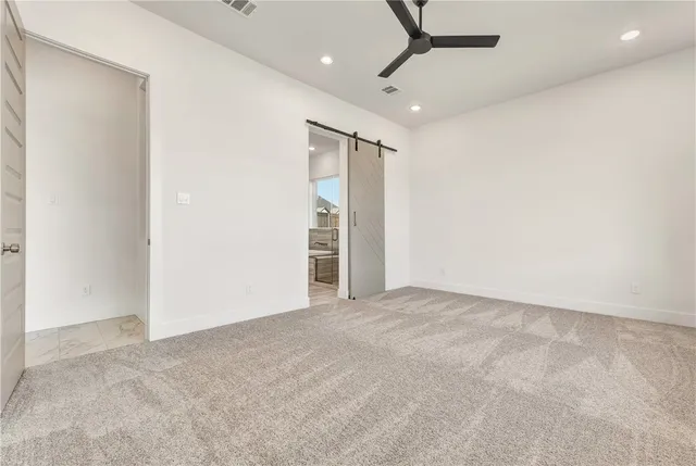 a large kitchen with stainless steel appliances kitchen island granite countertop a stove and a sink