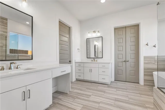 an empty room with closet and a ceiling fan