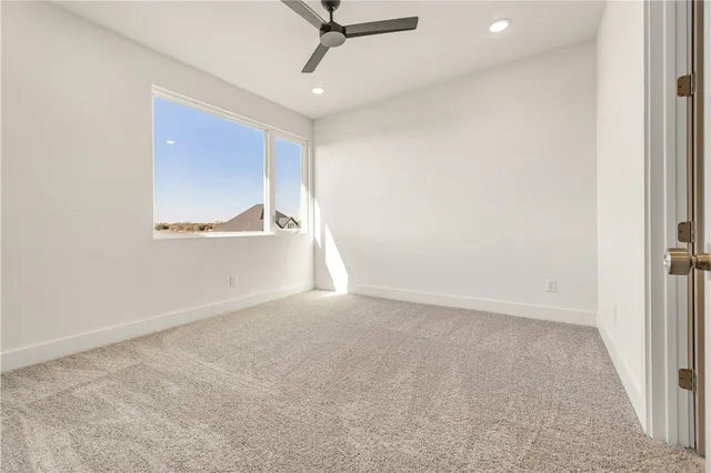 an empty room with kitchen appliances and windows