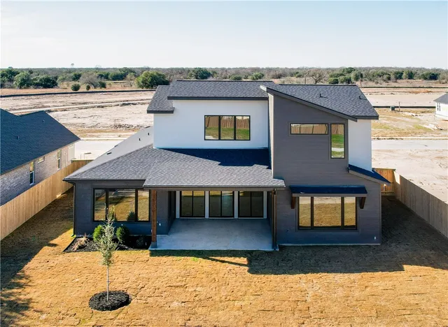 an empty room with a window and a ceiling fan
