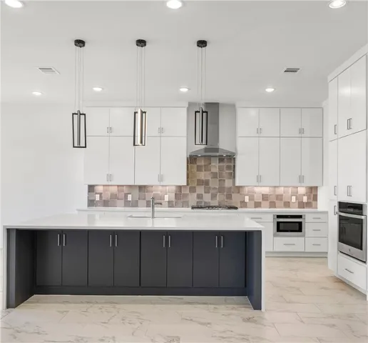 a view of kitchen with stainless steel appliances kitchen island cabinets and sink