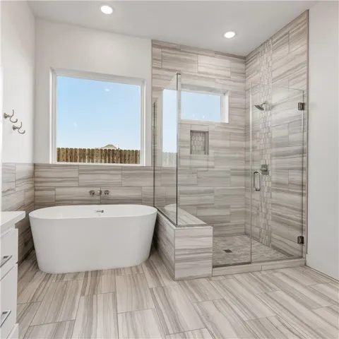 a spacious bathroom with a shower sink and mirror