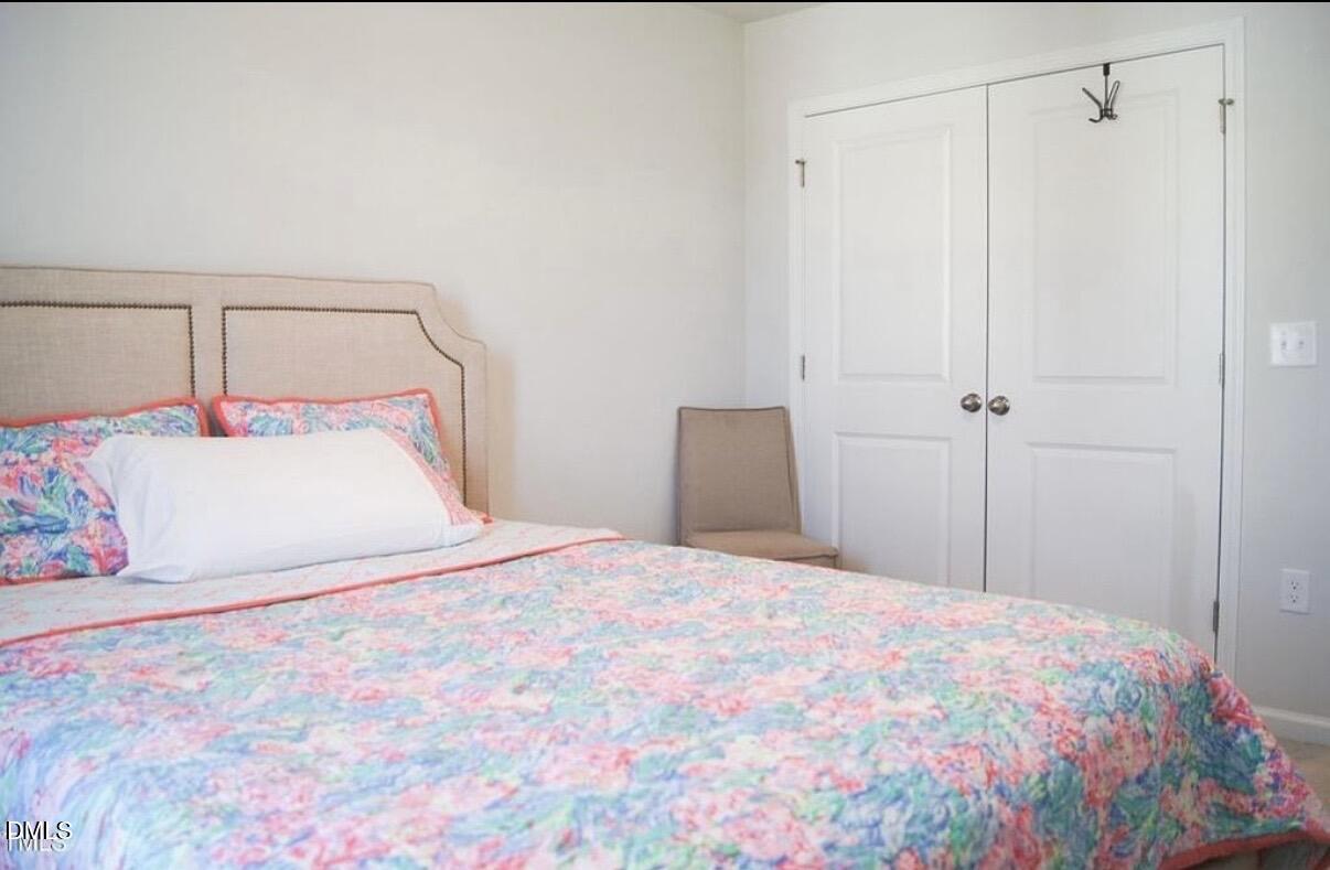 5006 Tura Street Raleigh, NC 27610 - Photo 26 of 32 a bedroom with a bed and a mirror