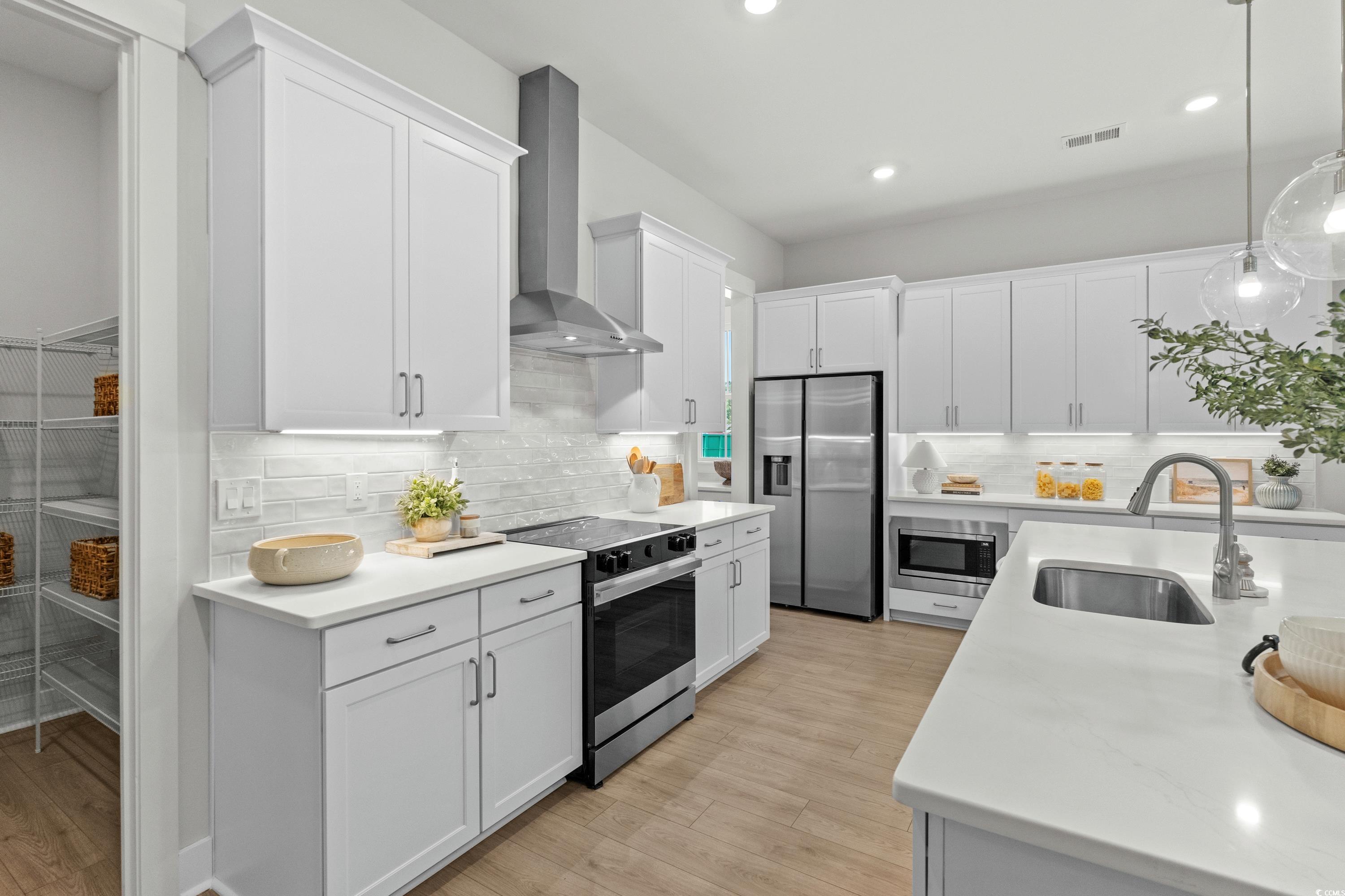 894 Foxtail Drive, Unit D41 Longs, SC 29568 - Photo 9 of 34 Kitchen featuring stainless steel appliances, white cabinetry, decorative light fixtures, tasteful backsplash, and recessed lighting