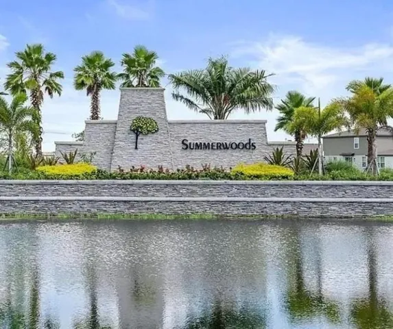 a view of a swimming pool with a patio and a garden