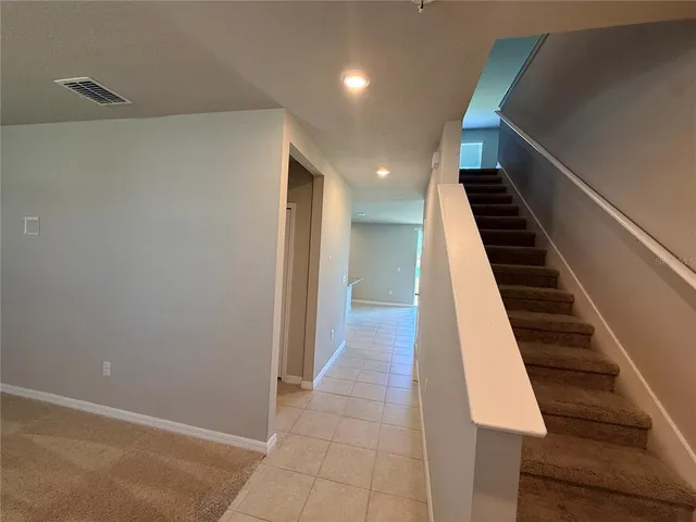 a kitchen with stainless steel appliances granite countertop a refrigerator and a stove