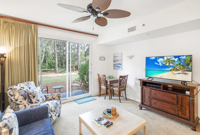 a view of a dining room with furniture and a potted plant