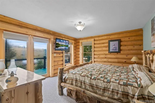 a bedroom with a large bed and a dresser