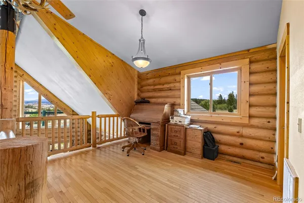 a view of livingroom with furniture wooden floor and windows