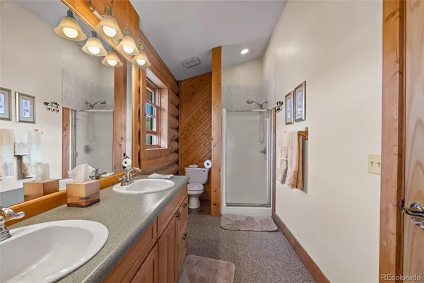 a bathroom with a sink double vanity granite and a mirror