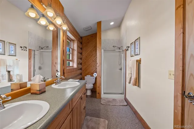 a bathroom with a sink double vanity granite and a mirror