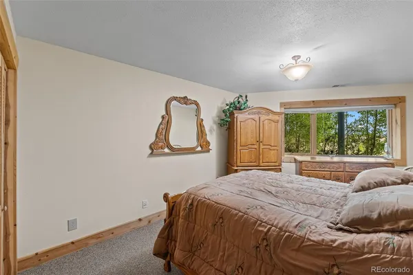 a bedroom with a large bed and a window