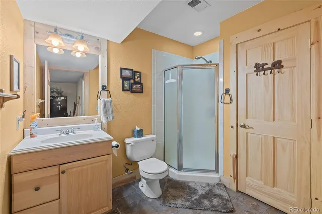 a bathroom with a toilet sink shower and mirror