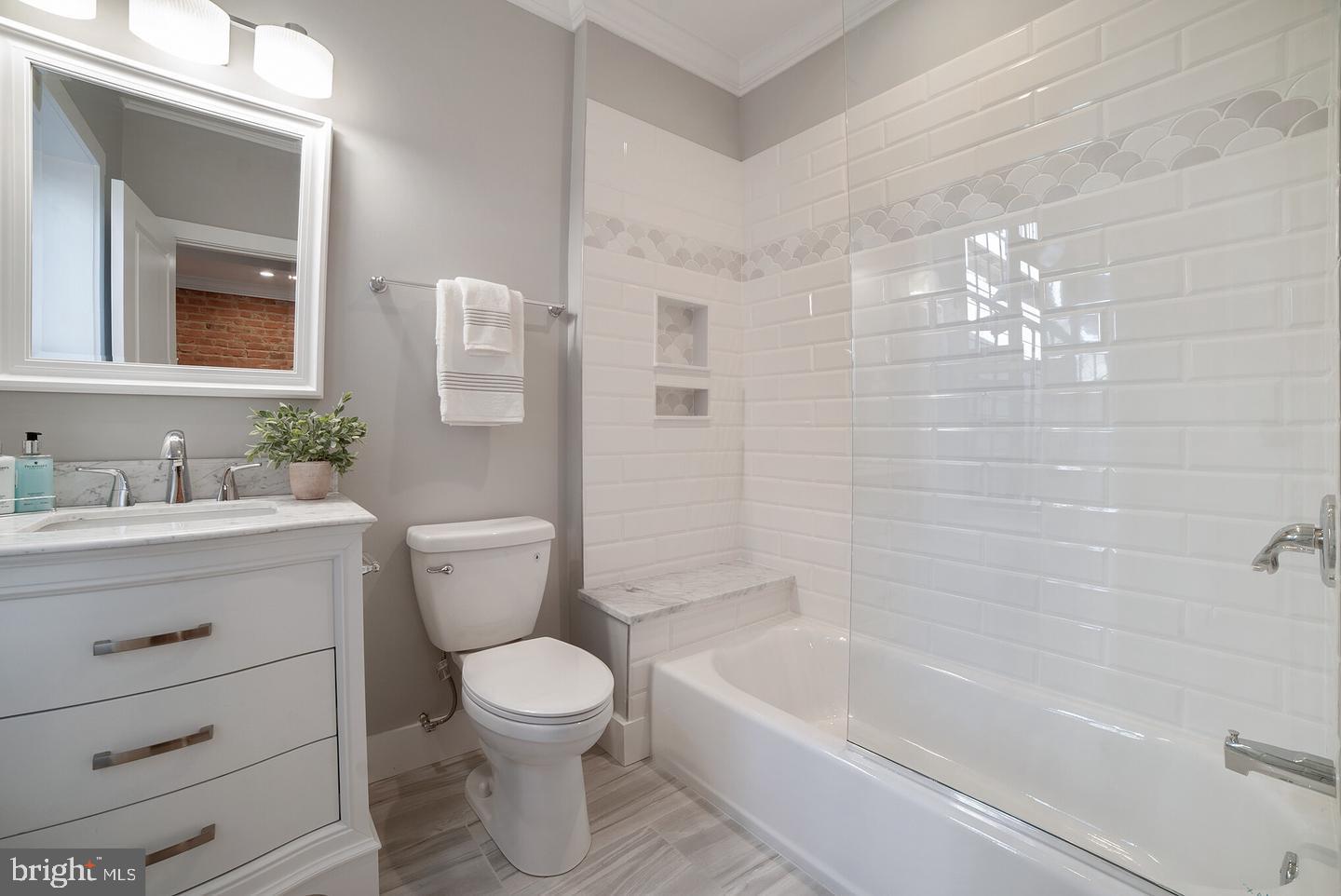 3425 O Donnell Street Baltimore, MD 21224 - Photo 13 of 29 a bathroom with a granite countertop toilet a sink and bathtub