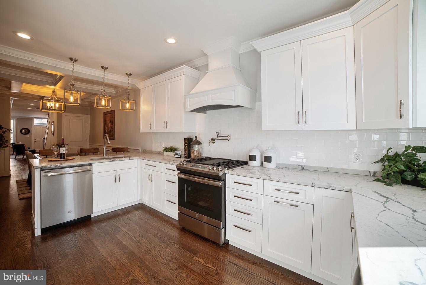 3425 O Donnell Street Baltimore, MD 21224 - Photo 8 of 29 a kitchen with granite countertop white cabinets and white appliances
