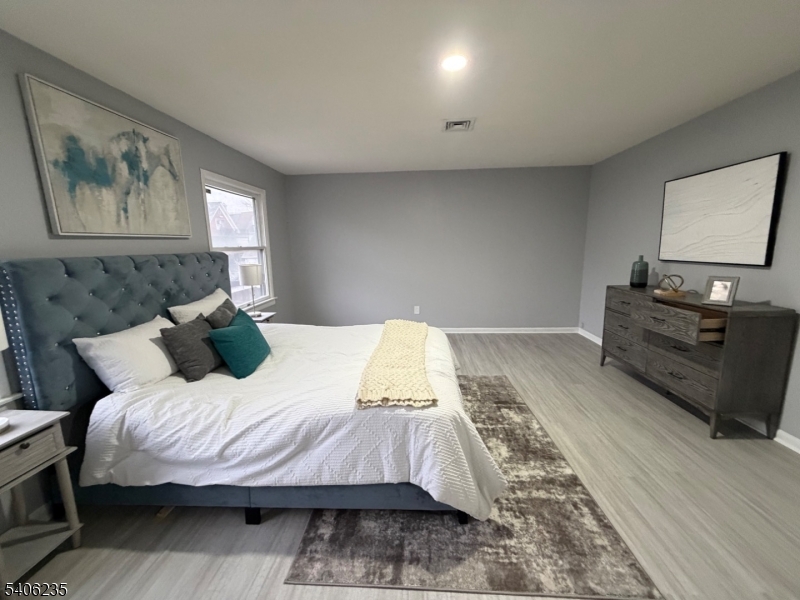 327 Bond Street Elizabeth Port, NJ 07206 - Photo 12 of 22 a bedroom with a bed and a flat screen tv