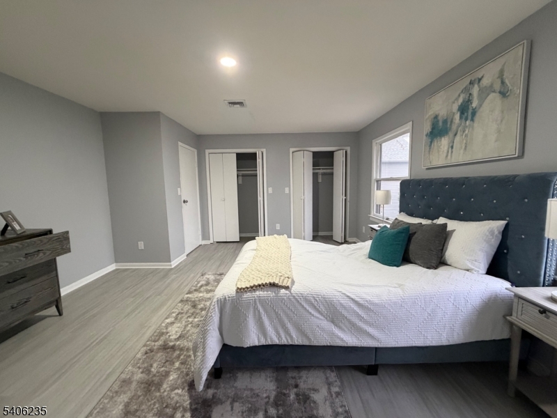 327 Bond Street Elizabeth Port, NJ 07206 - Photo 14 of 22 a bedroom with a bed and wooden floor