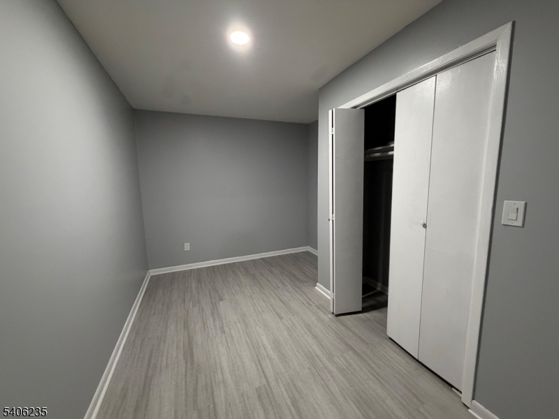 327 Bond Street Elizabeth Port, NJ 07206 - Photo 19 of 22 an empty room with wooden floor and closet