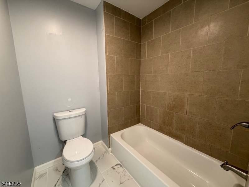 327 Bond Street Elizabeth Port, NJ 07206 - Photo 20 of 22 a bath room with a toilet and a bath tub