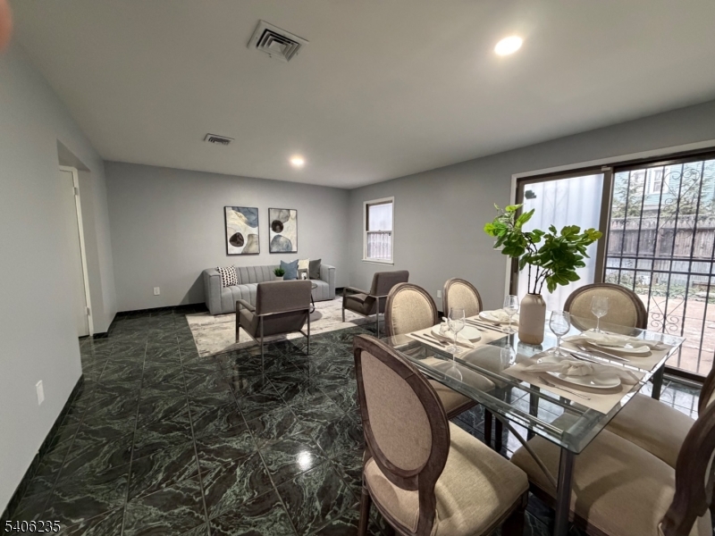 327 Bond Street Elizabeth Port, NJ 07206 - Photo 3 of 22 a living room with furniture potted plant and a large window