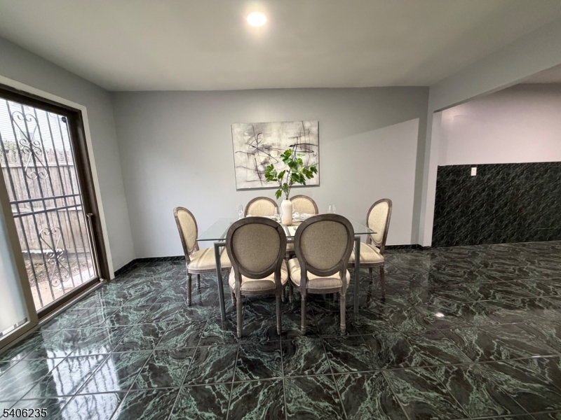 327 Bond Street Elizabeth Port, NJ 07206 - Photo 4 of 22 a view of a dining room with furniture a rug and wooden floor