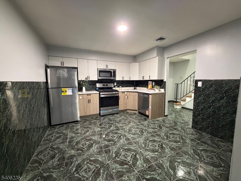 327 Bond Street Elizabeth Port, NJ 07206 - Photo 8 of 22 a kitchen with a stove a refrigerator and a sink