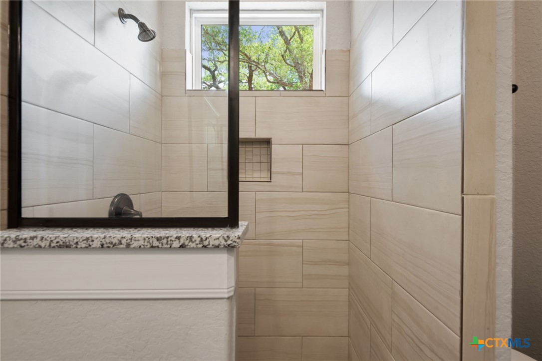 192 Weatherby Drive Spring Branch, TX 78070 - Photo 19 of 24 a bathroom with a granite countertop window and a white door