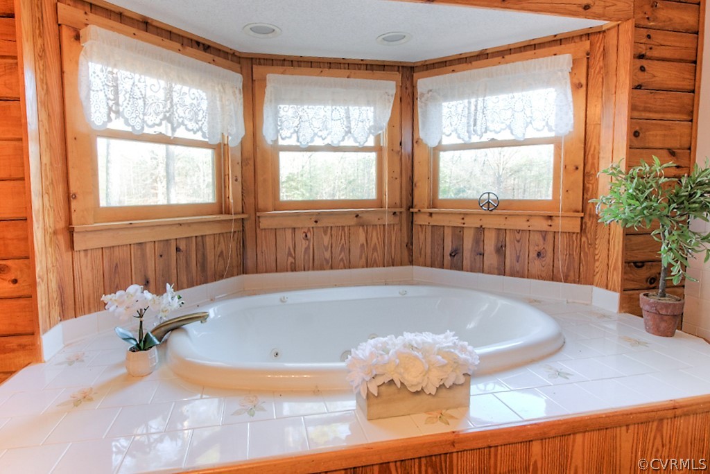 21363 Horseshoe Road Carson, VA 23830 - Photo 33 of 43 a bath tub sitting in a bathroom next to a window