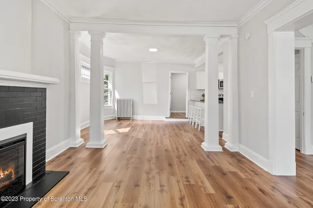 a view of a kitchen with wooden floor and electronic appliances