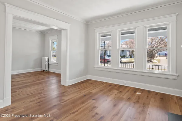 a dining room with furniture and wooden floor