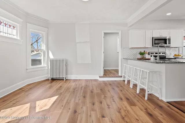 a view of wooden floor and a window