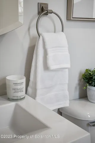 a living room with furniture and a lamp