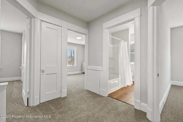 an empty room with windows and closet