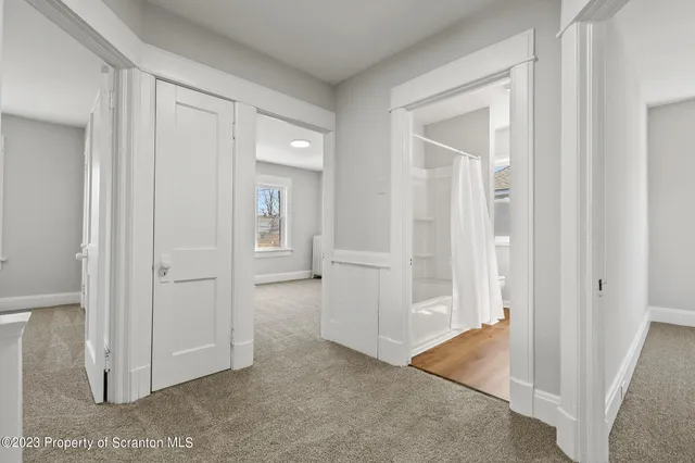 an empty room with windows and closet