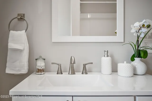 a view of a house with a wooden fence