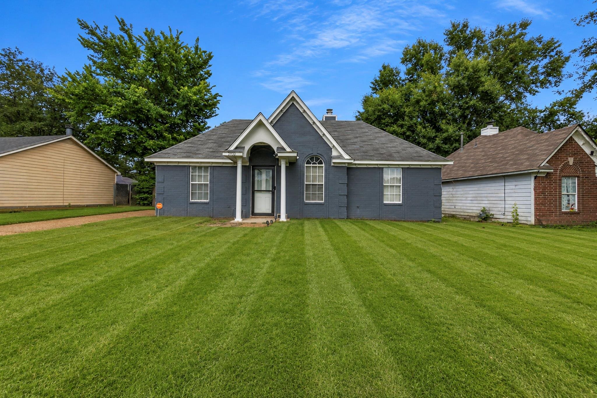 5930 Chadwell Road Millington, TN 38053 - Photo 1 of 17 Single-story residence featuring a blue painted brick exterior and a gabled entry