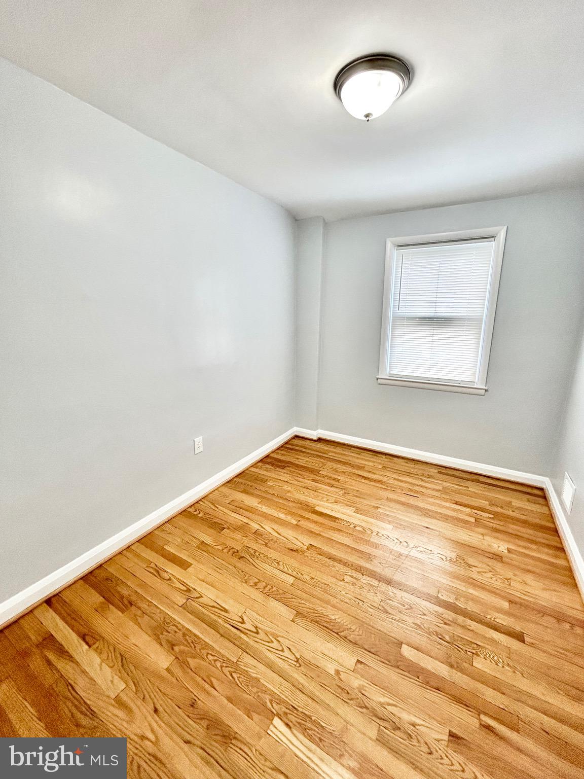 6116 Edlynne Road Baltimore, MD 21239 - Photo 13 of 18 a view of empty room with wooden floor