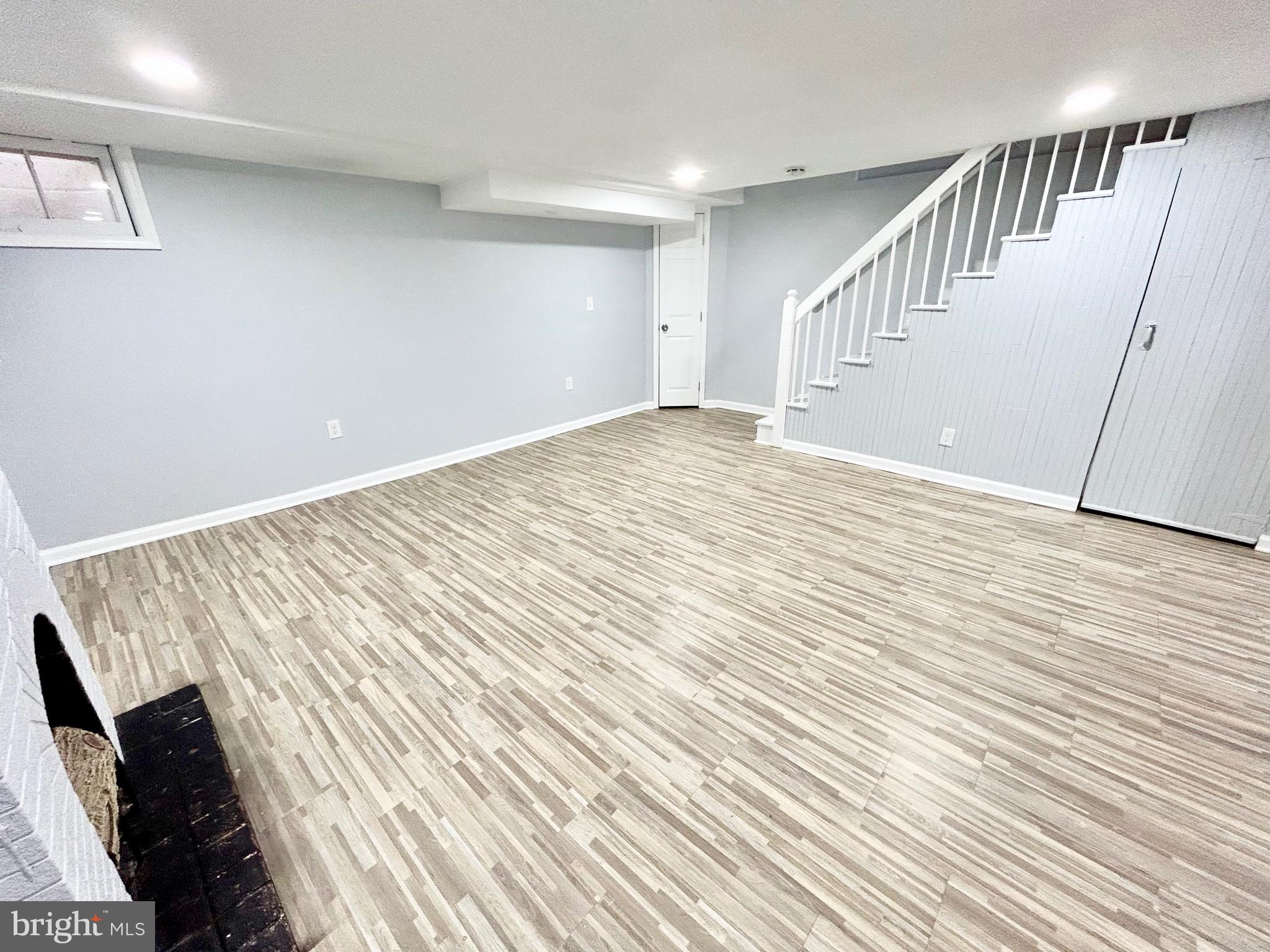 6116 Edlynne Road Baltimore, MD 21239 - Photo 15 of 18 a view of an empty room with wooden floor