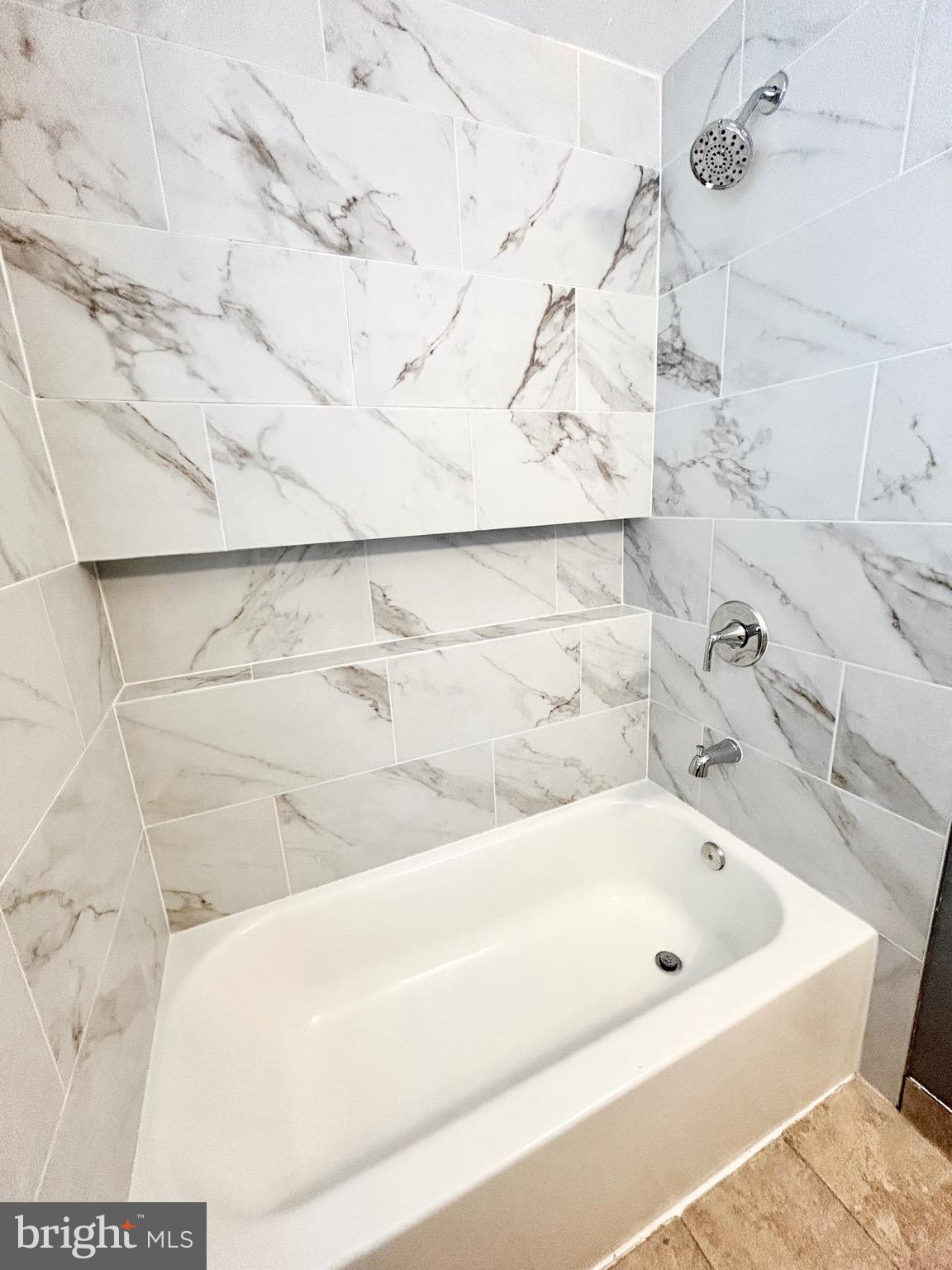 6116 Edlynne Road Baltimore, MD 21239 - Photo 8 of 18 a bathroom with a bathtub