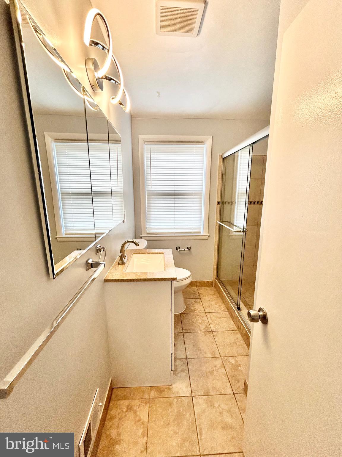 6116 Edlynne Road Baltimore, MD 21239 - Photo 9 of 18 a bathroom with a sink toilet and shower