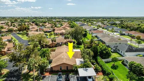 an aerial view of residential houses with outdoor space and swimming pool