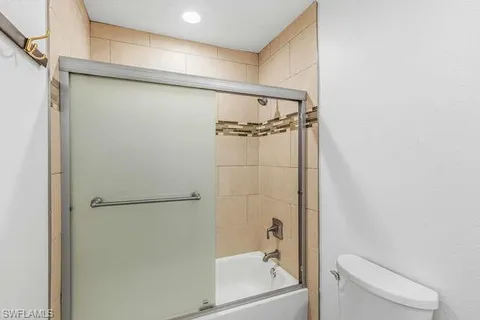 a bathroom with a shower and a toilet