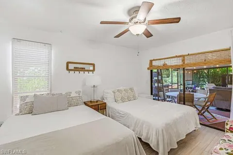 a spacious bedroom with two large bed and a large window