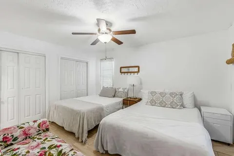 a bedroom with two beds and a chandelier
