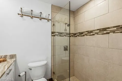 a bathroom with a shower a toilet and a sink