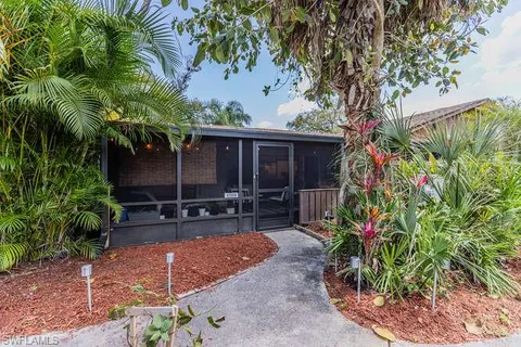 a backyard of a house with yard and outdoor seating