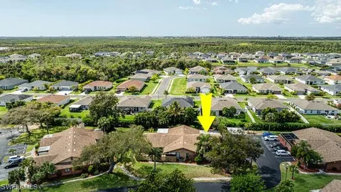 an aerial view of residential houses with outdoor space and ocean view