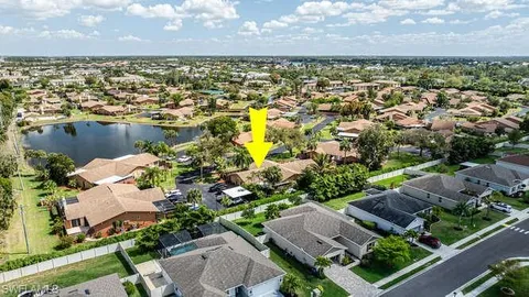 an aerial view of residential houses with outdoor space and lake view